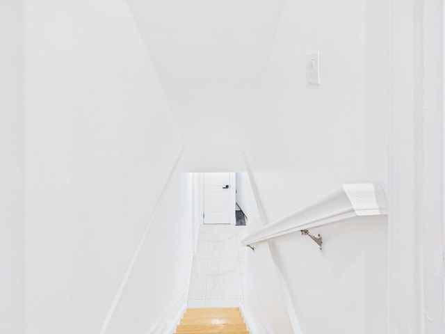 stairs featuring wood finished floors