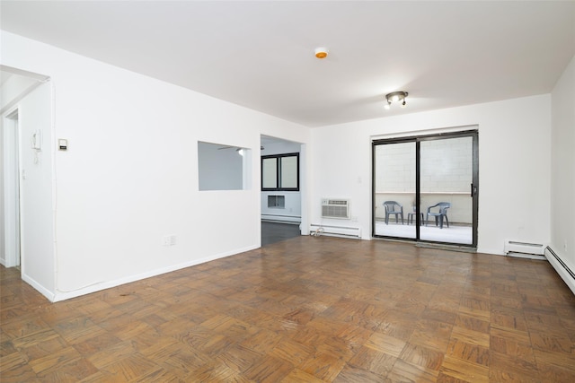 spare room with a baseboard heating unit, baseboards, a wall mounted air conditioner, and a baseboard radiator