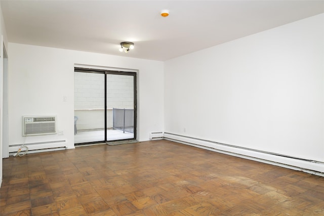 spare room featuring baseboard heating and a wall unit AC