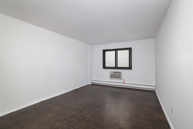 empty room with a baseboard heating unit, baseboards, and an AC wall unit