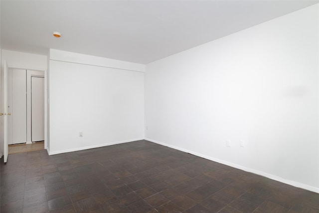 unfurnished room featuring baseboards