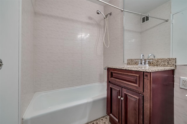 bathroom featuring visible vents, vanity, and bathtub / shower combination