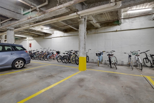 garage featuring bike storage and concrete block wall