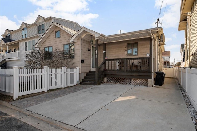 view of front of home featuring a porch and fence private yard