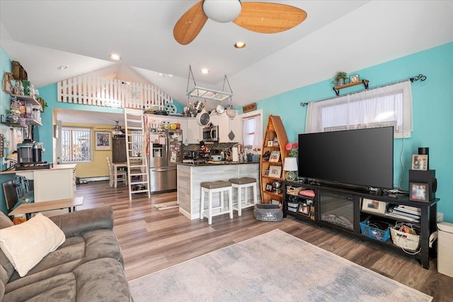 living room with recessed lighting, lofted ceiling, wood finished floors, and a ceiling fan