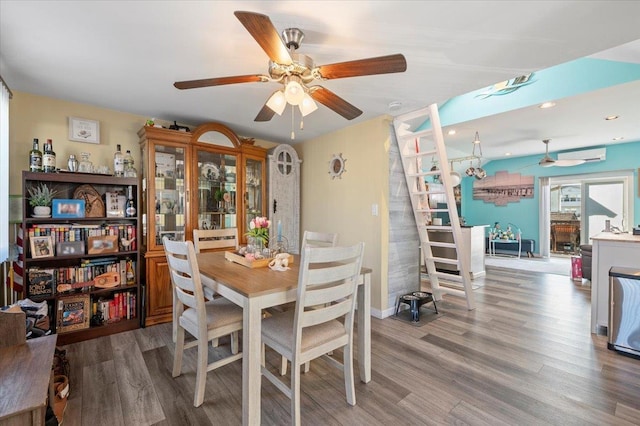 dining space with baseboards, ceiling fan, and wood finished floors