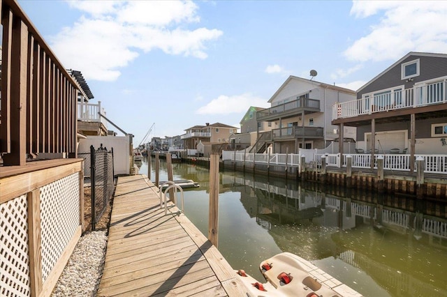 dock area with a residential view and a water view