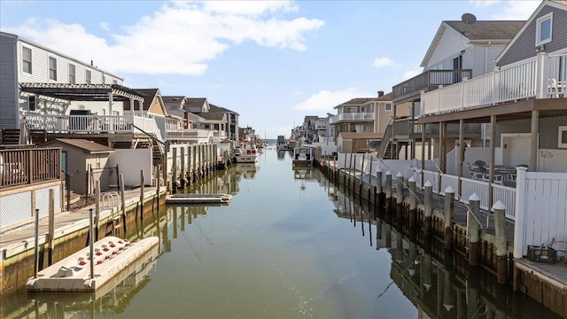 view of dock featuring a residential view and a water view