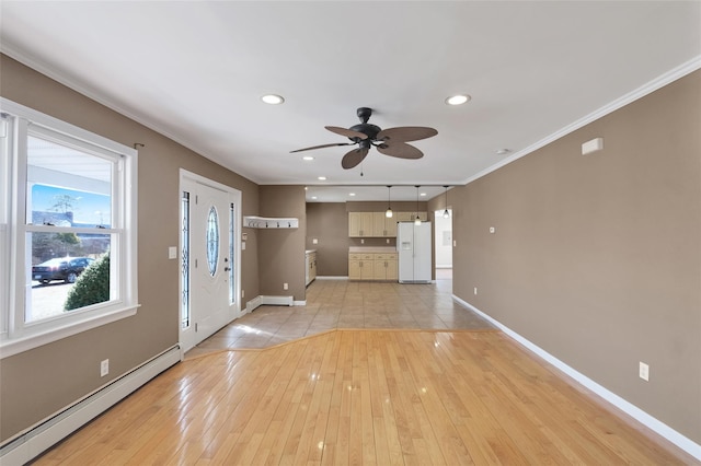 entryway featuring a baseboard radiator, baseboards, light wood-style floors, and ornamental molding