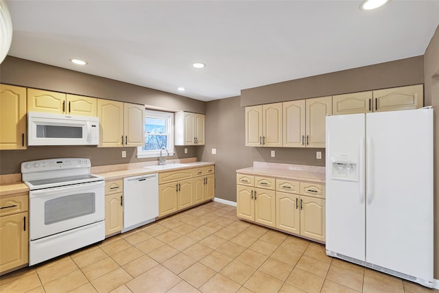 kitchen featuring light countertops, light tile patterned floors, recessed lighting, white appliances, and a sink