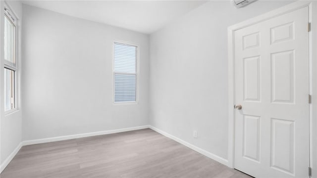 empty room with baseboards and wood finished floors