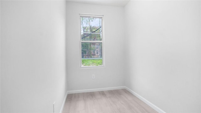 unfurnished room featuring light wood-style floors and baseboards