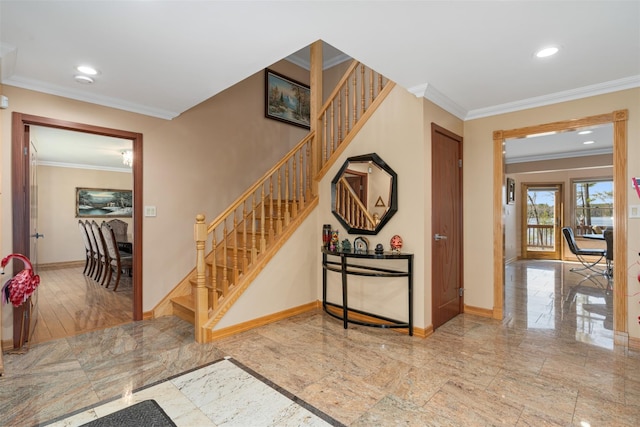 foyer featuring stairway, baseboards, and ornamental molding