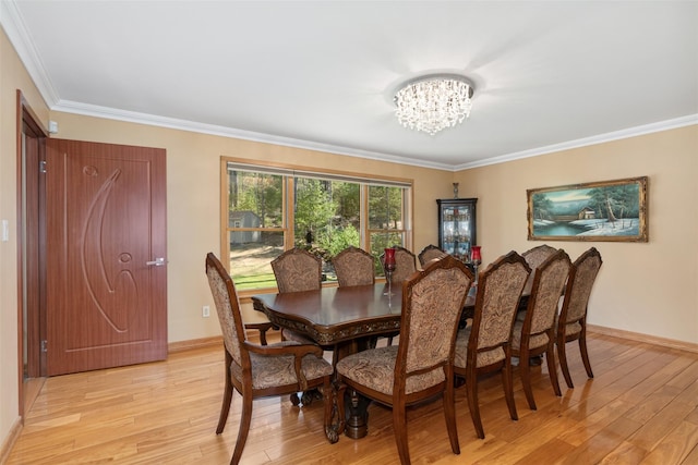 dining space featuring an inviting chandelier, baseboards, light wood-type flooring, and ornamental molding