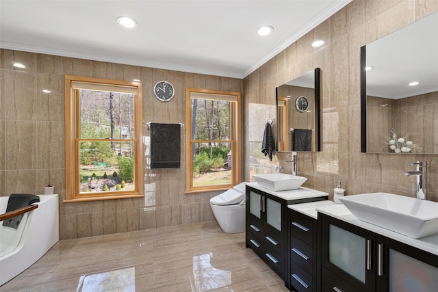 full bathroom with plenty of natural light, tile walls, and a sink