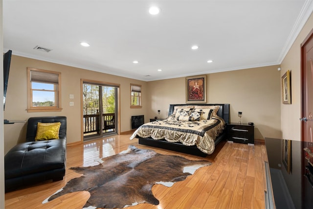 bedroom featuring visible vents, access to exterior, ornamental molding, and light wood-style flooring