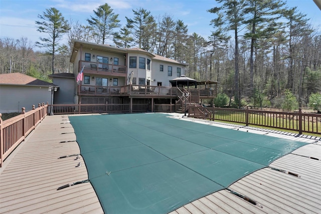 view of swimming pool with a fenced in pool and a wooden deck