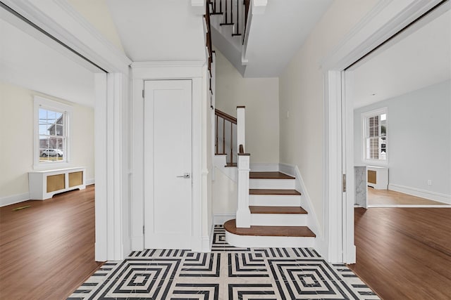 stairs featuring wood finished floors and baseboards