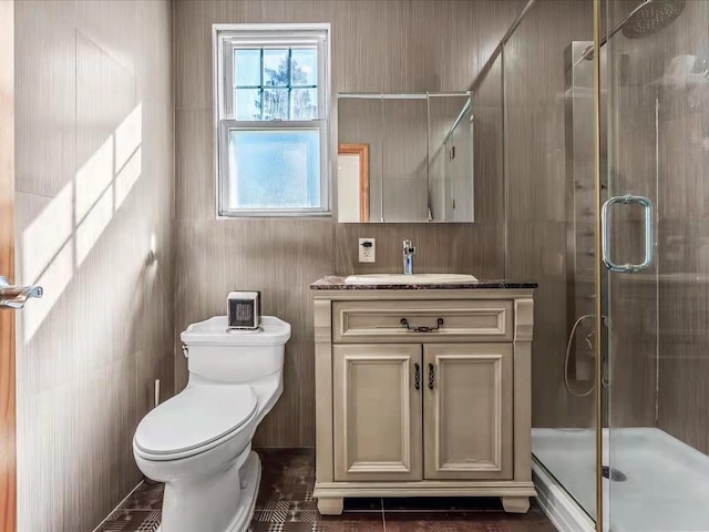 full bath featuring a shower stall, vanity, and toilet