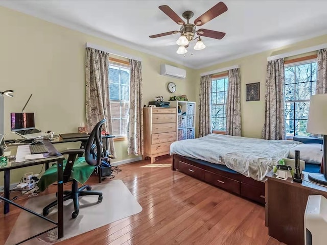 bedroom featuring multiple windows, a wall mounted air conditioner, crown molding, and hardwood / wood-style floors