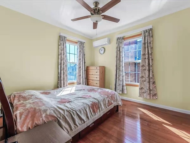 bedroom with an AC wall unit, a ceiling fan, baseboards, and hardwood / wood-style floors