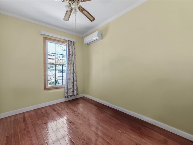 unfurnished room with a wall mounted air conditioner, crown molding, baseboards, and hardwood / wood-style flooring