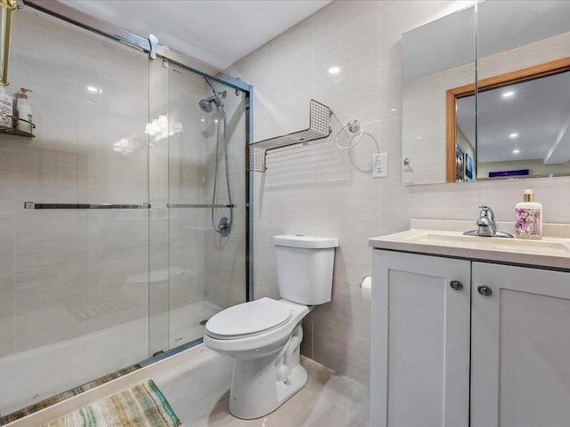 full bath with toilet, a stall shower, tile walls, tile patterned flooring, and vanity