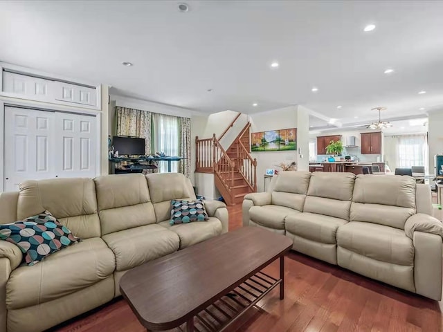 living room with stairs, recessed lighting, and wood finished floors