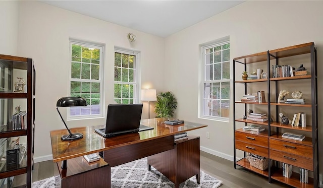 home office with baseboards and dark wood-style flooring