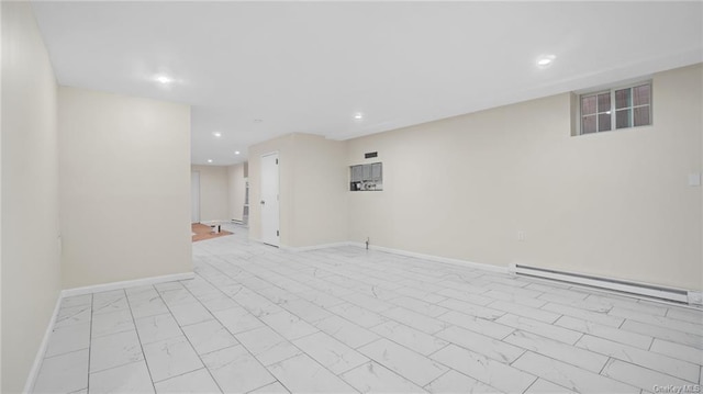 unfurnished room with recessed lighting, marble finish floor, a baseboard heating unit, and baseboards