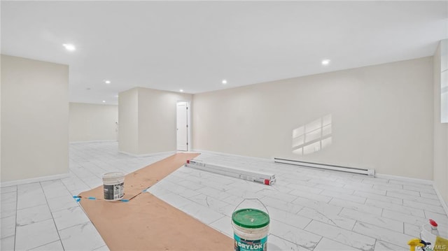 workout area featuring recessed lighting, marble finish floor, baseboard heating, and baseboards