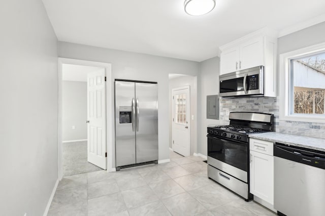 kitchen featuring light stone counters, baseboards, decorative backsplash, appliances with stainless steel finishes, and white cabinetry