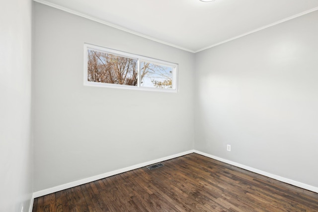 spare room with visible vents, crown molding, dark wood-type flooring, and baseboards