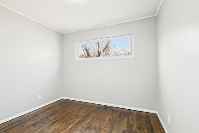 unfurnished room featuring visible vents, baseboards, dark wood-type flooring, and crown molding