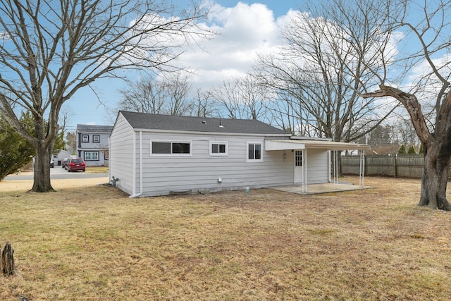 back of house featuring a patio, fence, and a lawn