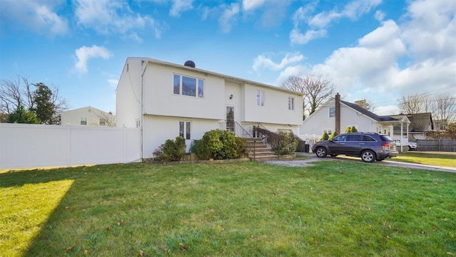 view of front facade featuring a front yard and fence