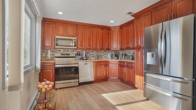 kitchen with decorative backsplash, light stone countertops, visible vents, and appliances with stainless steel finishes