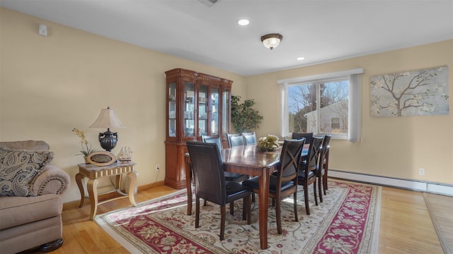 dining area with recessed lighting, wood finished floors, baseboards, and a baseboard radiator