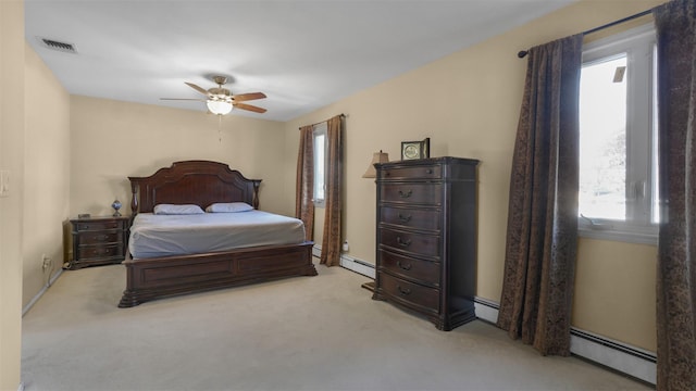 bedroom featuring a baseboard heating unit, light colored carpet, visible vents, and ceiling fan