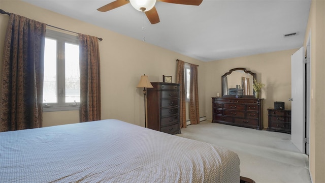 bedroom featuring visible vents, light colored carpet, and a ceiling fan