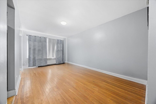 empty room featuring light wood-style flooring and baseboards