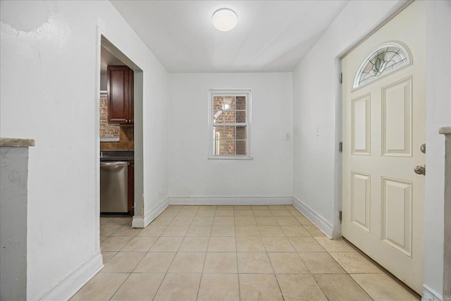 entrance foyer featuring light tile patterned flooring and baseboards