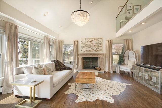 living room featuring plenty of natural light, high vaulted ceiling, and wood finished floors