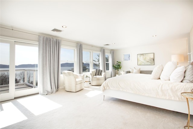 carpeted bedroom with visible vents, recessed lighting, and access to outside