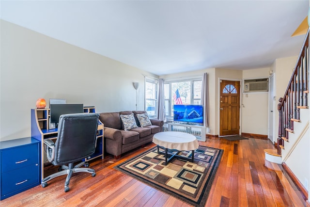 office space with a wall mounted air conditioner, baseboards, and hardwood / wood-style floors