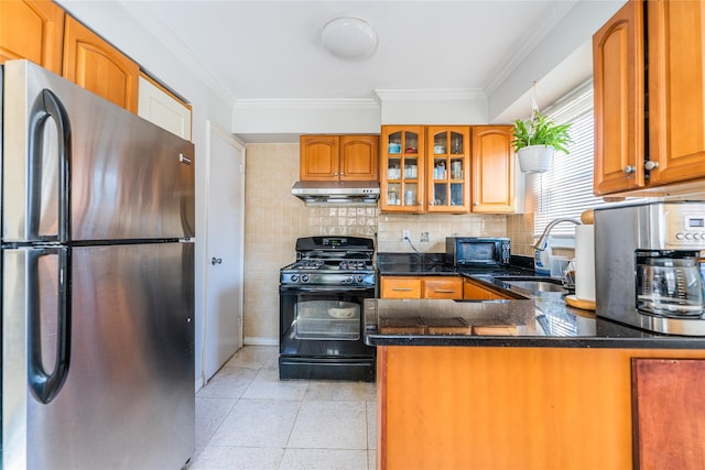 kitchen featuring glass insert cabinets, crown molding, exhaust hood, black appliances, and a sink