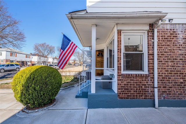 view of exterior entry with brick siding