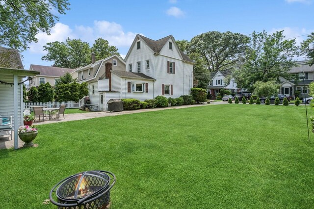 73 Spruce Ave, Floral Park, NY 11001 - view of yard featuring a patio and an outdoor fire pit