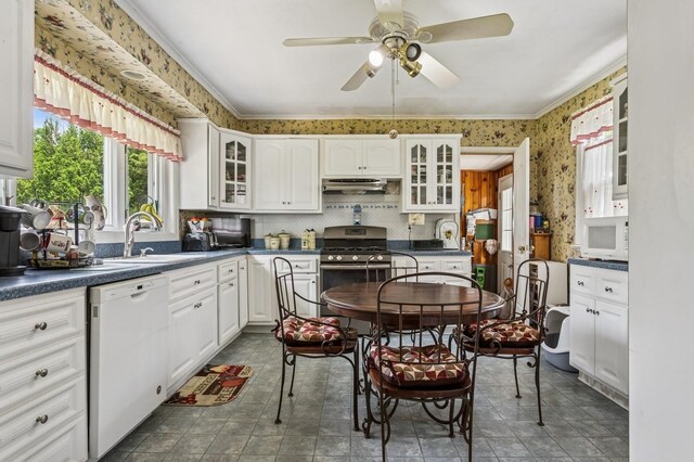 73 Spruce Ave, Floral Park, NY 11001 - kitchen featuring white appliances, under cabinet range hood, wallpapered walls, dark countertops, and white cabinets