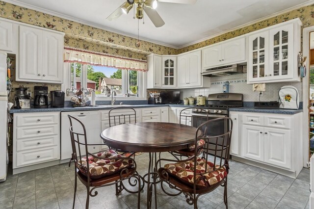 73 Spruce Ave, Floral Park, NY 11001 - kitchen with white dishwasher, under cabinet range hood, stainless steel range with gas cooktop, a ceiling fan, and dark countertops